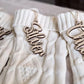 Personalized laser-cut wooden name ornament for Christmas stockings.