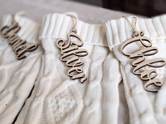 Personalized laser-cut wooden name ornament for Christmas stockings.